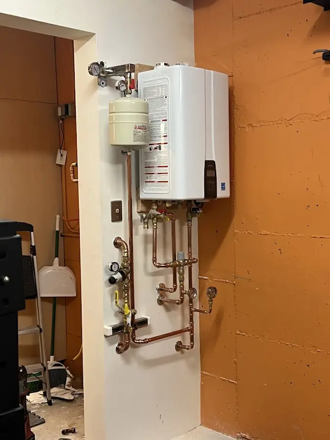 Plumbing technician inspecting water heater connections in Riviera Beach